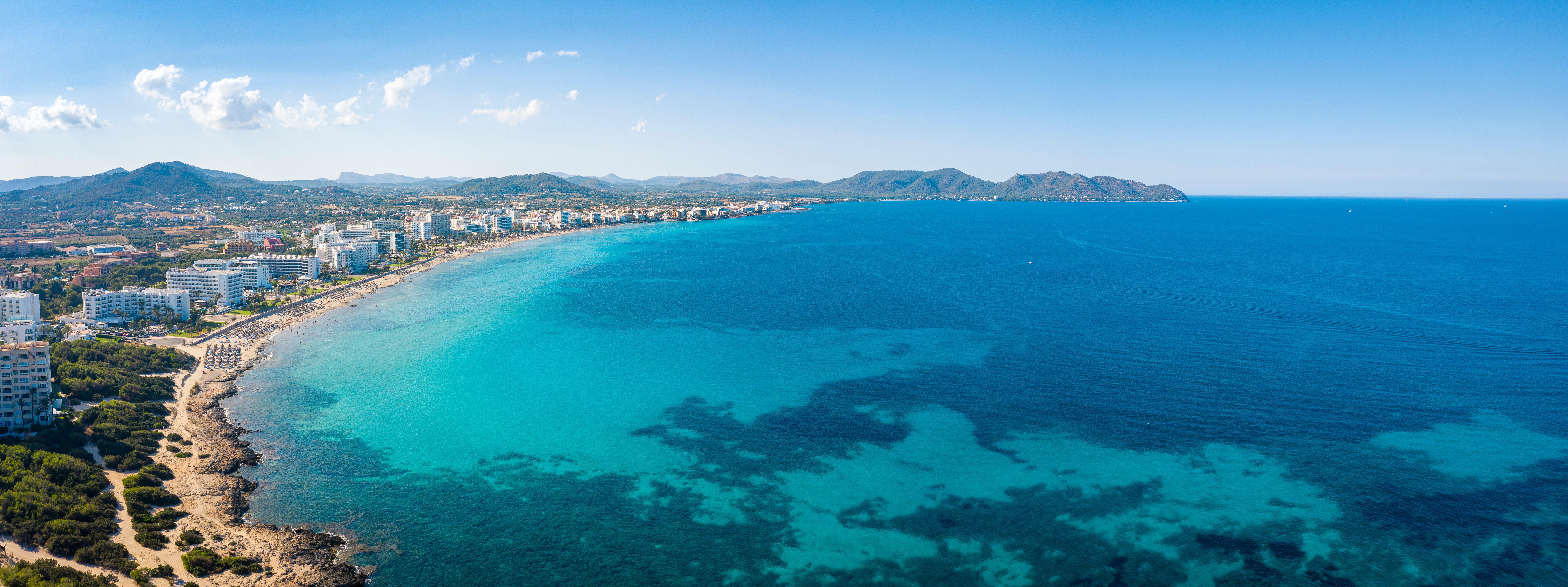 Drone-opname van de baai en het strand van Cala Millor met turquoise zee