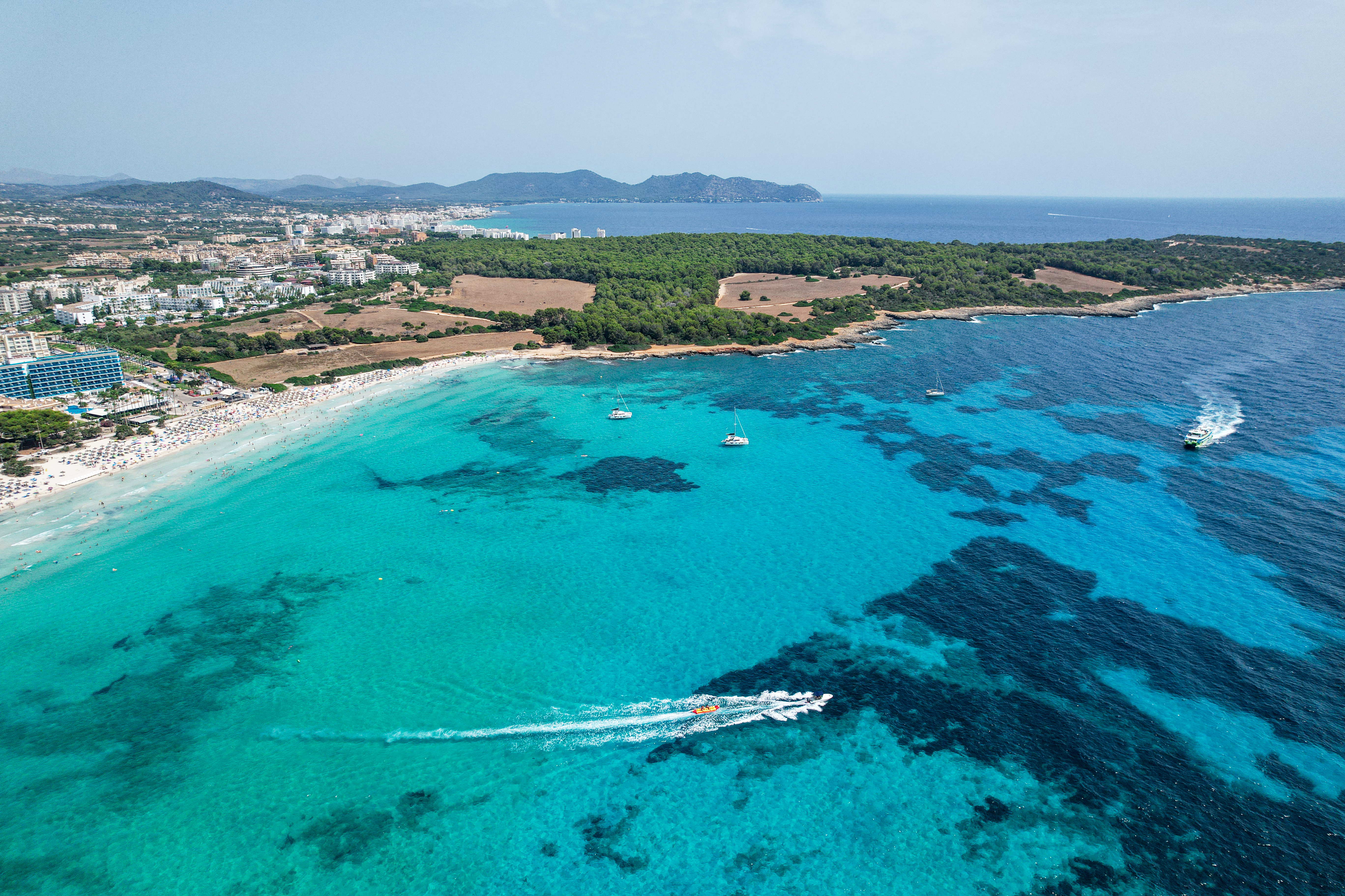 Bird's eye view of turquoise, crystal clear sea water in Sa Coma