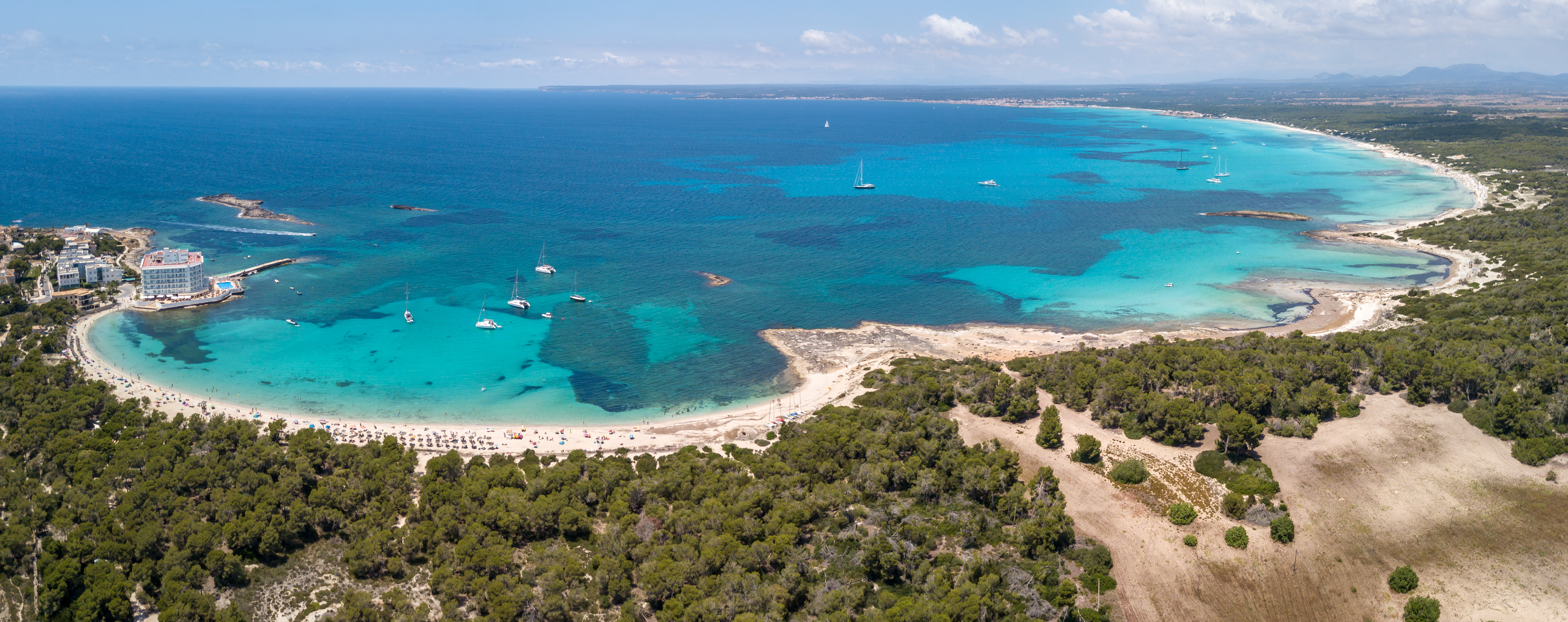 Luchtfoto van Colonia Sant Jordi. Hier begint het prachtige strand van Es Trenc. In het midden van het natuurreservaat Ses Salines strekt het zich uit over 6 km