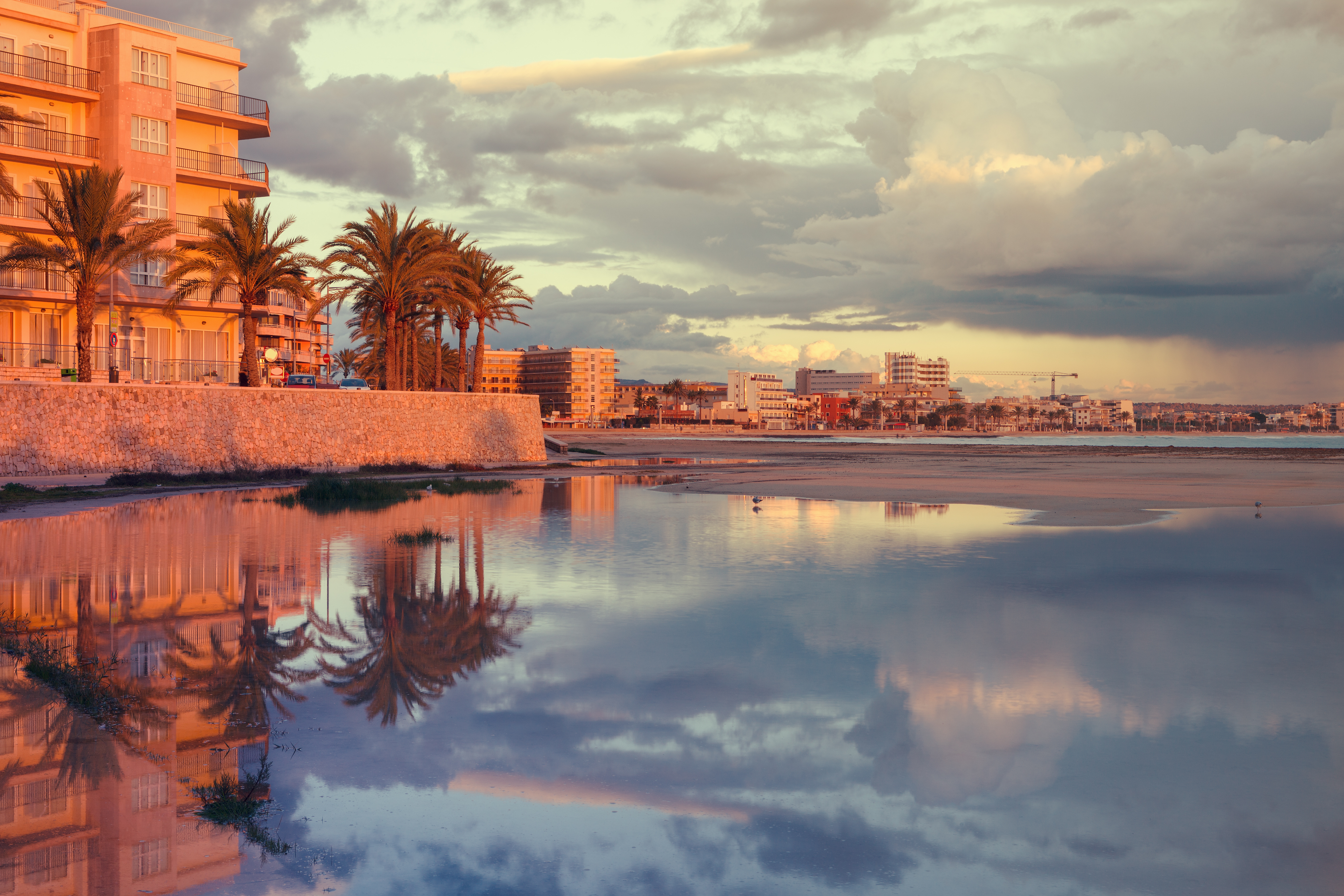 Evening atmosphere in Can Pastilla. The clouds are reflected in the crystal clear water