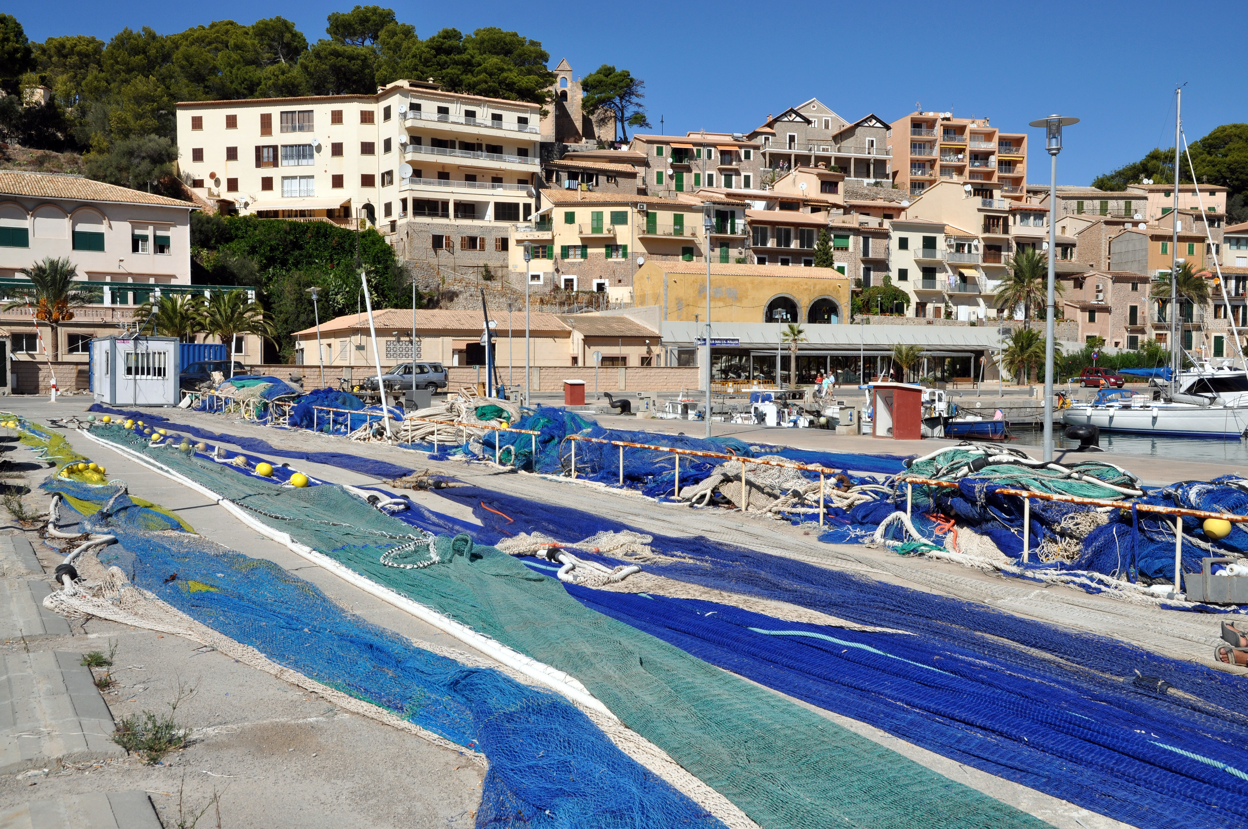 Fishermen have spread out their nets. In the background, the old town of Port de Soller