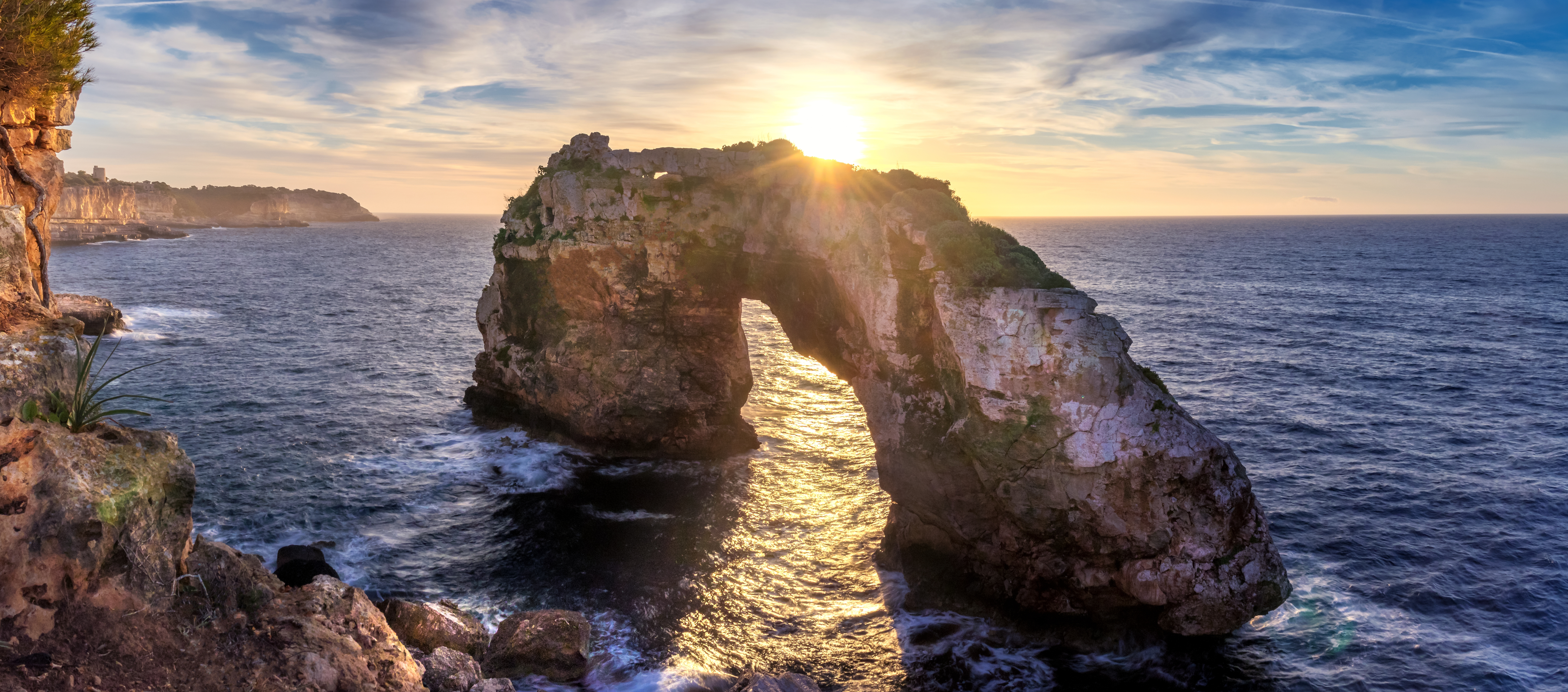 The setting sun illuminates the rock on the coast of Santanyi