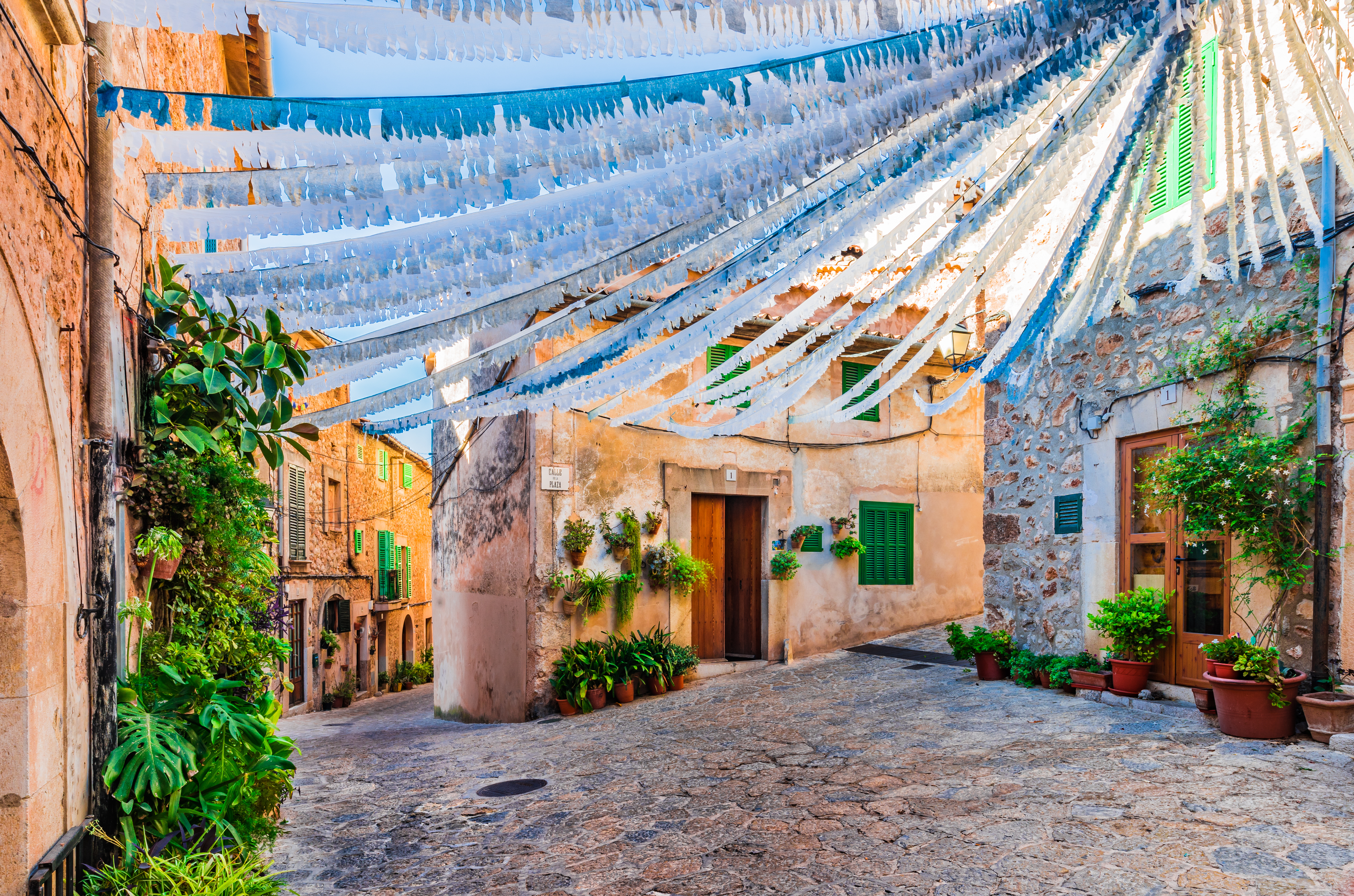 Calle adornada en un callejón con casas antiguas en Valldemossa