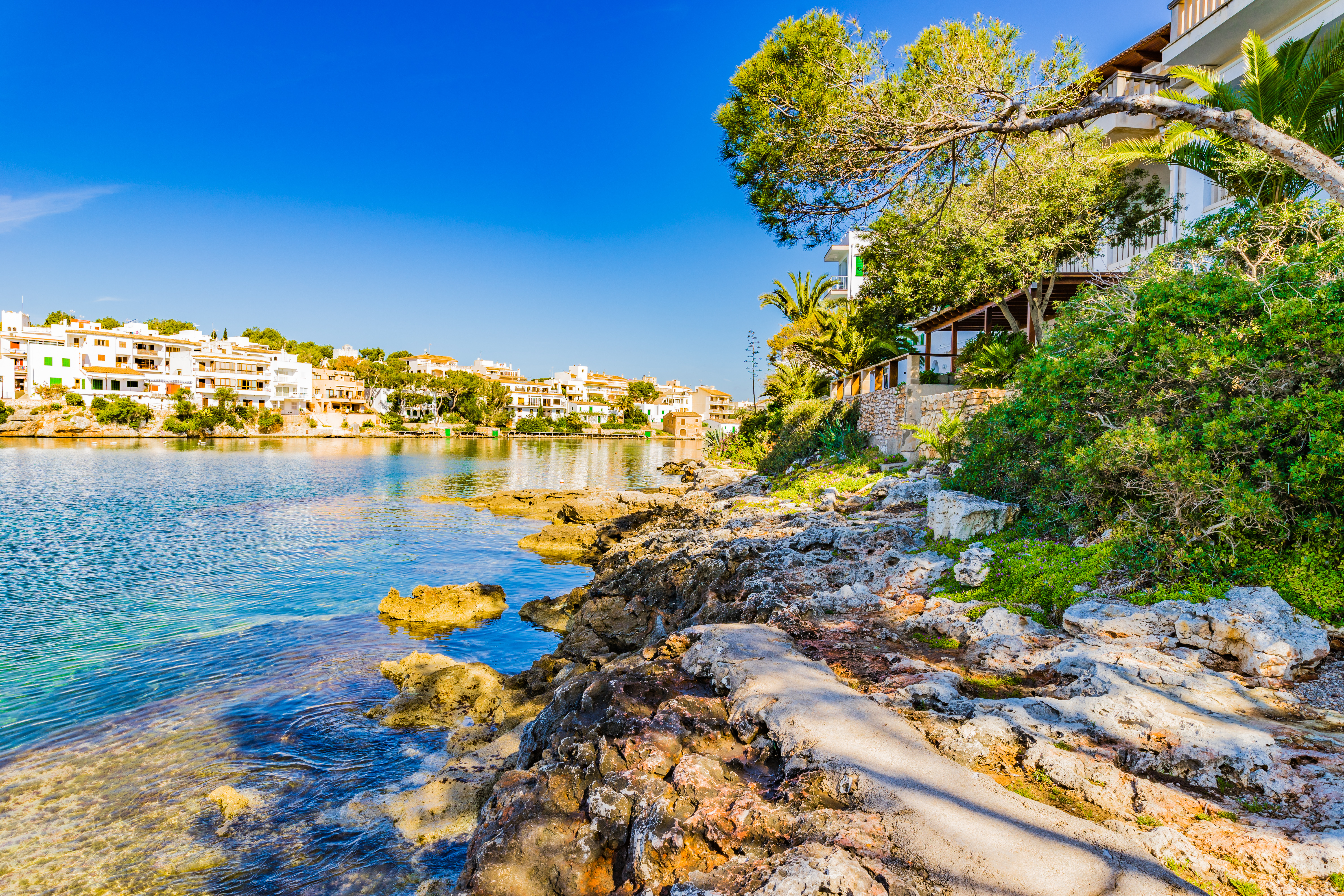 Rocky coast of Porto Petro with stunning colors from dark blue to turquoise