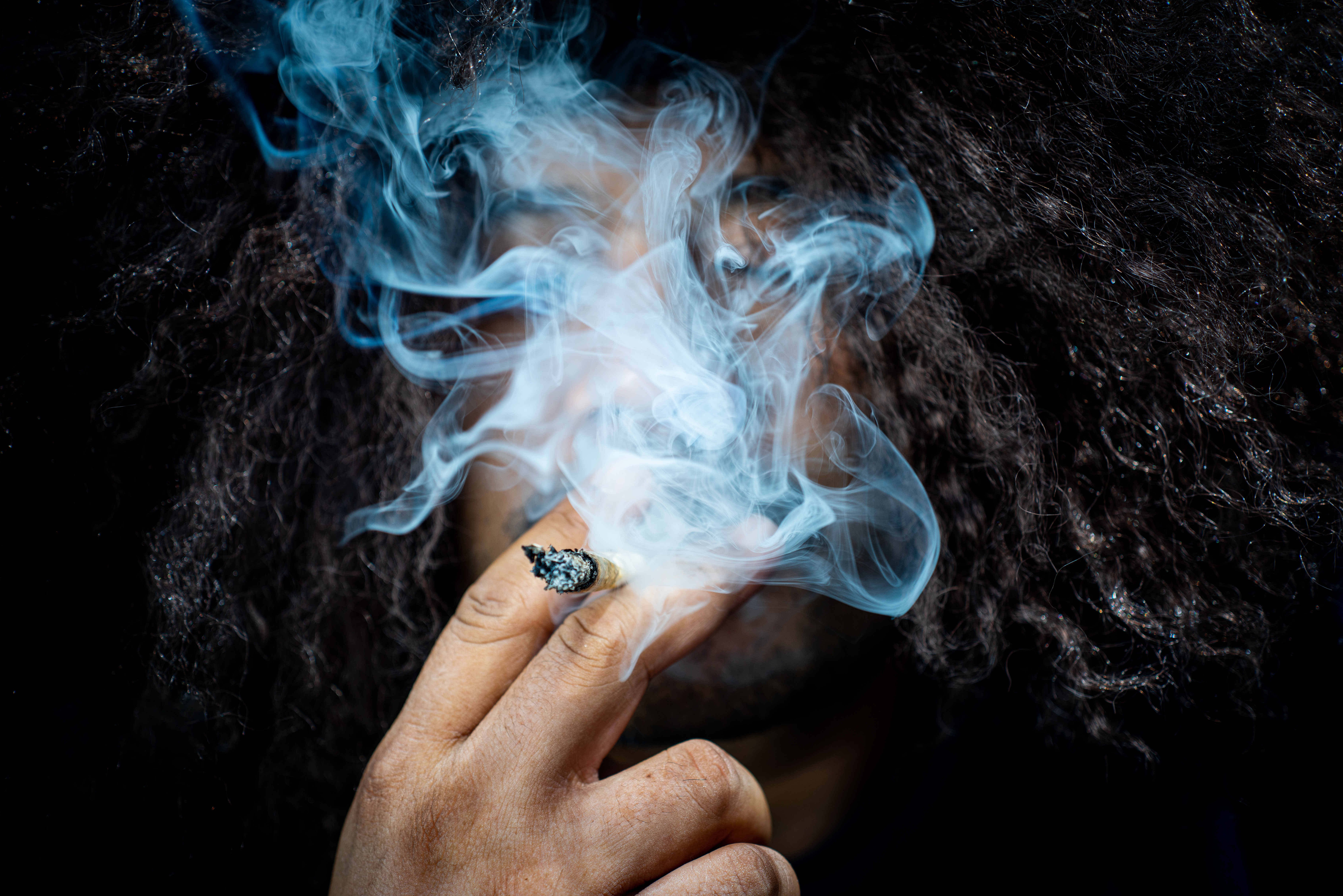 A smoker enjoying a joint with fresh cannabis purchased at a Cannabis Social Club (CSC) in Cala Ferrera