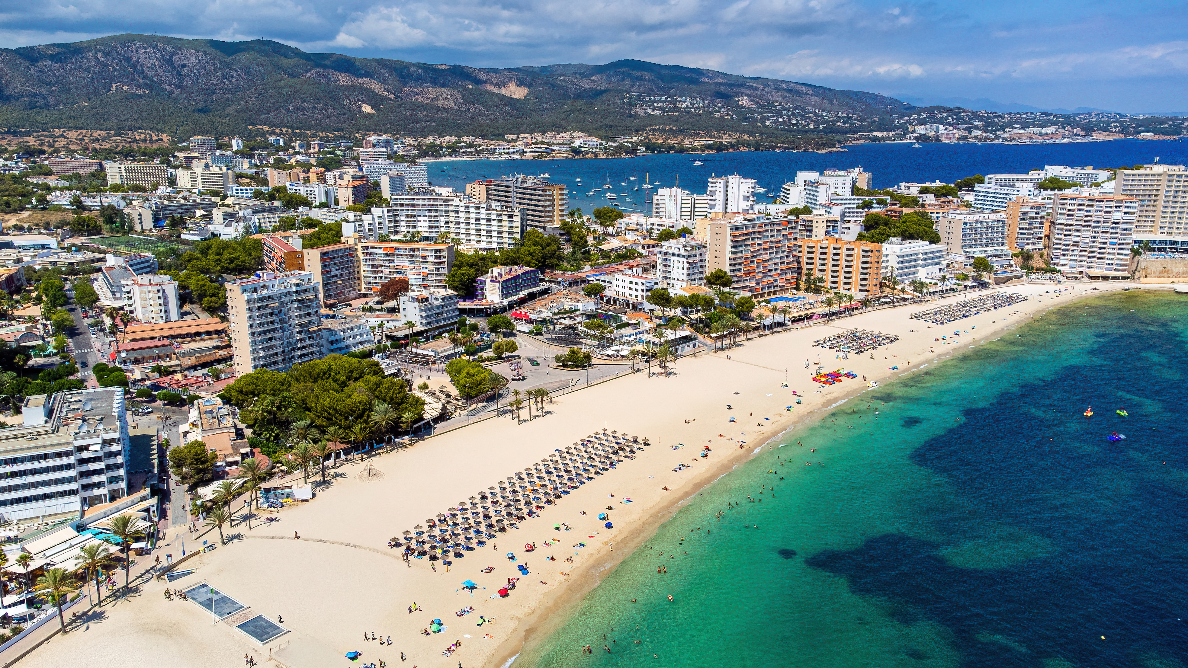 Bird's-eye view over the beaches of Magaluf with mountains in the background